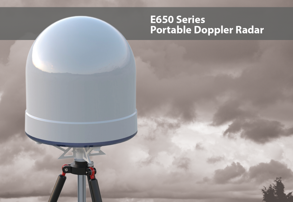 The compact E650 Series Portable Dopplar Radar displayed outside, without the legs, beneath a cloudy sky.