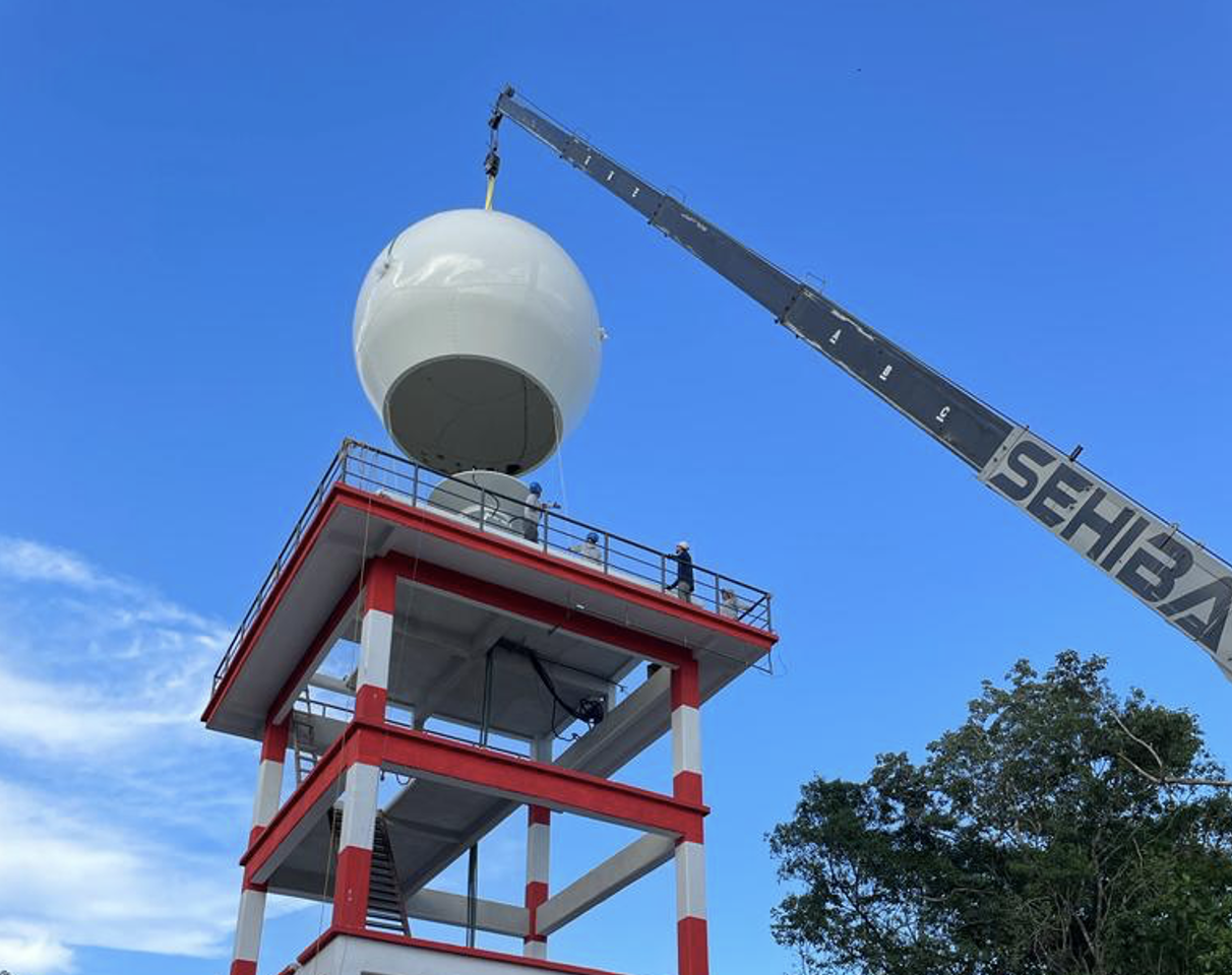 A crane lowering the large dome piece on the E800 X Band radar during installation, located in Mexico City, Mexico.