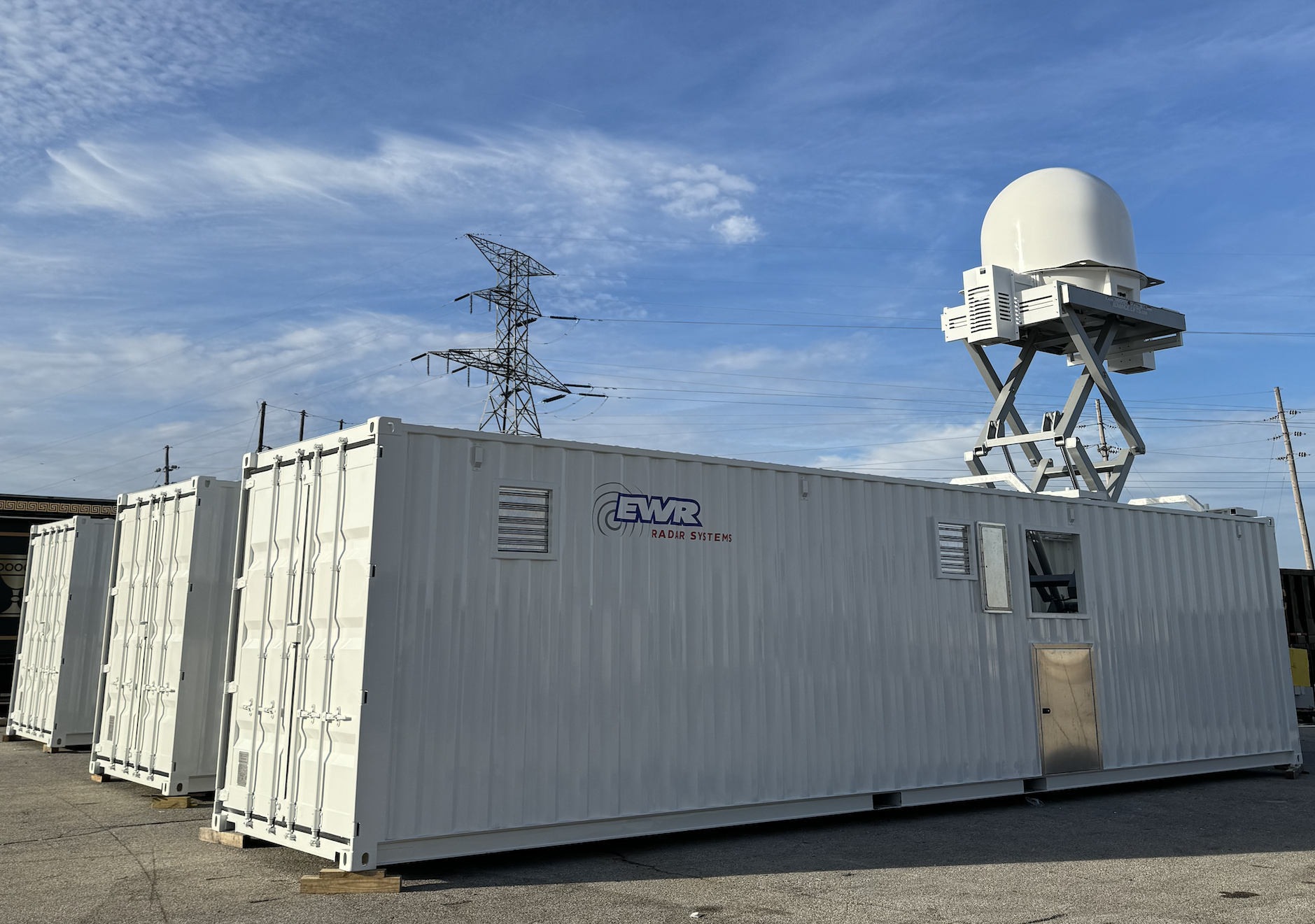 A radar from EWR Radar Systems installed on a retractable platform within a portable shipping container, elevated for use.